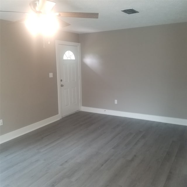 interior space with dark hardwood / wood-style floors and ceiling fan