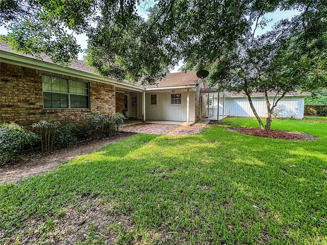 ranch-style house featuring a front lawn and a patio area