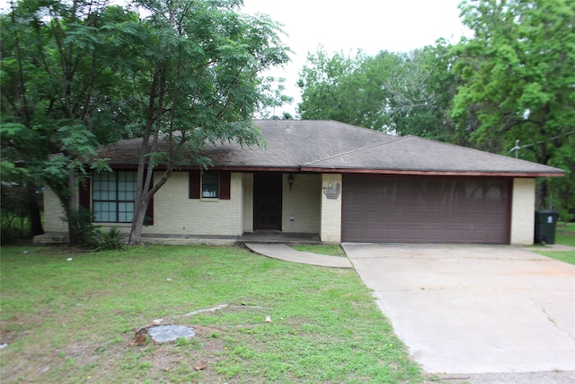 ranch-style house with a garage and a front yard