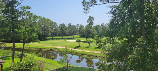 view of home's community featuring a water view and a yard