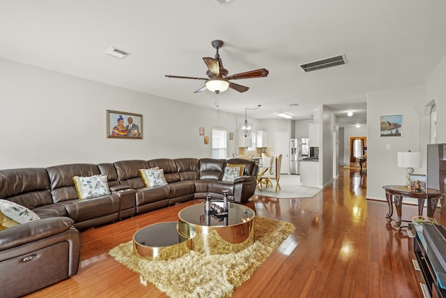 living room featuring ceiling fan and light hardwood / wood-style floors