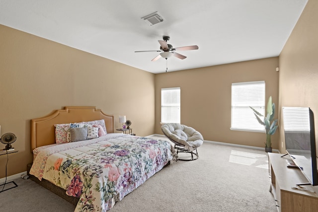 bedroom featuring ceiling fan, carpet floors, and multiple windows