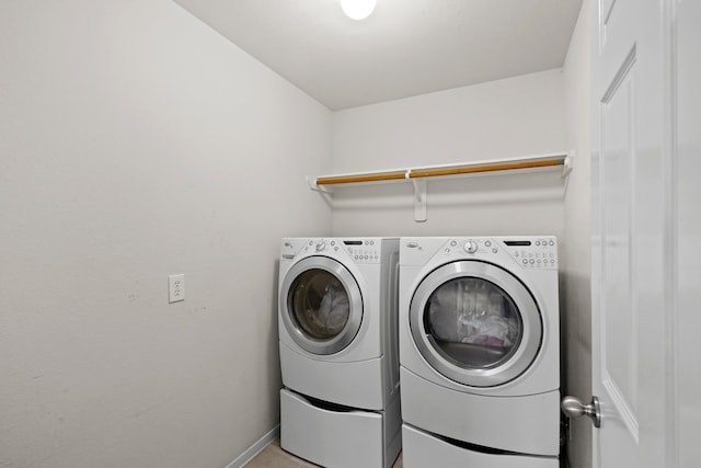 clothes washing area with washing machine and dryer