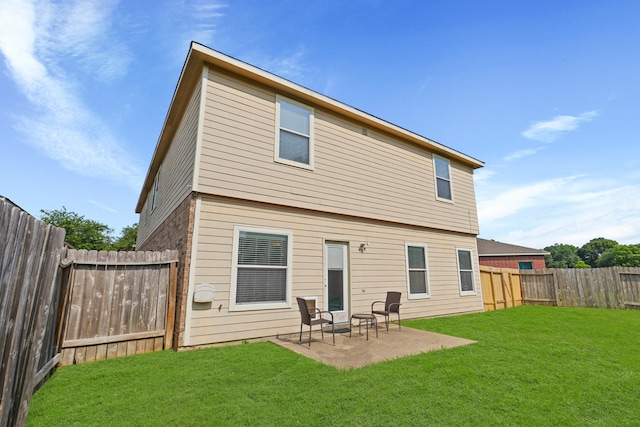 back of house with a yard and a patio area