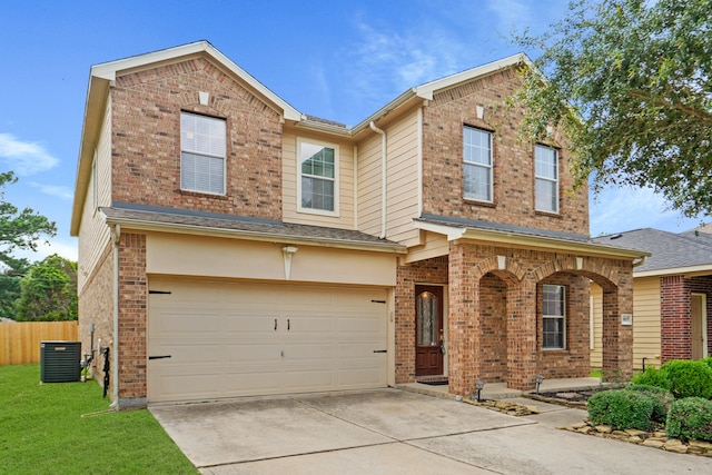 view of front of home with a garage and central AC