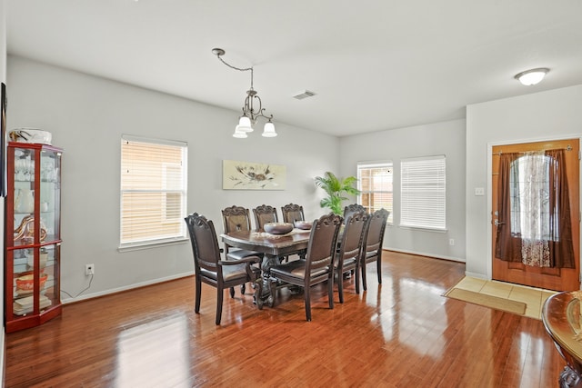 dining space featuring a chandelier and wood-type flooring