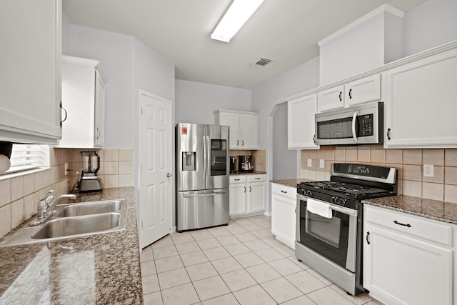 kitchen featuring stainless steel appliances, backsplash, and sink