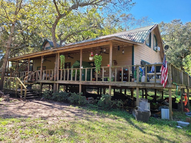 rear view of house featuring ceiling fan and a deck