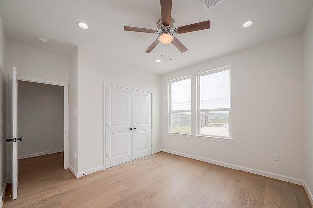 unfurnished bedroom with a closet, ceiling fan, and light wood-type flooring