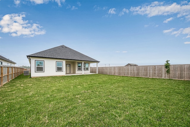 rear view of property featuring a lawn