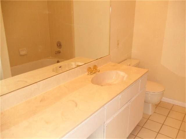 full bathroom featuring tile floors, washtub / shower combination, vanity, and toilet