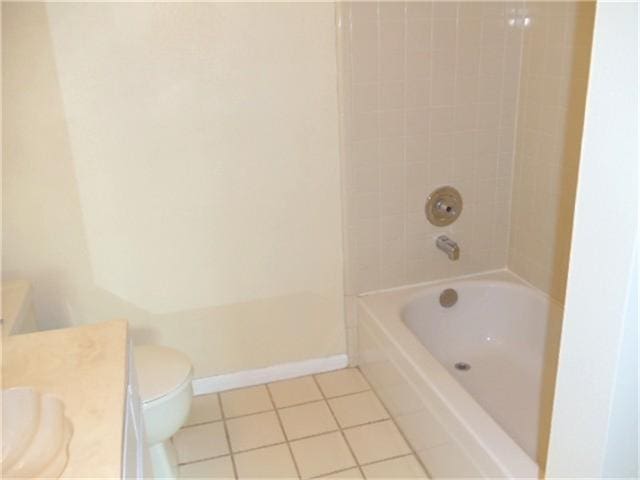 full bathroom with tile flooring, vanity, toilet, and tiled shower / bath