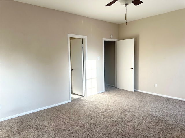 carpeted spare room with ceiling fan