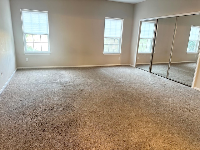 unfurnished bedroom with carpet flooring and a closet