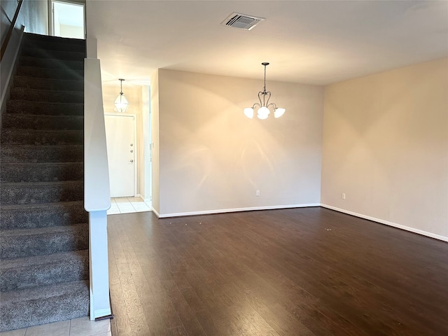 interior space featuring dark hardwood / wood-style floors and an inviting chandelier