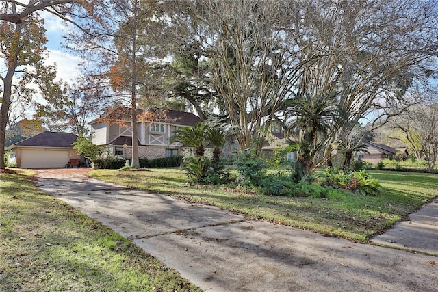 view of front of property featuring a garage and a front lawn