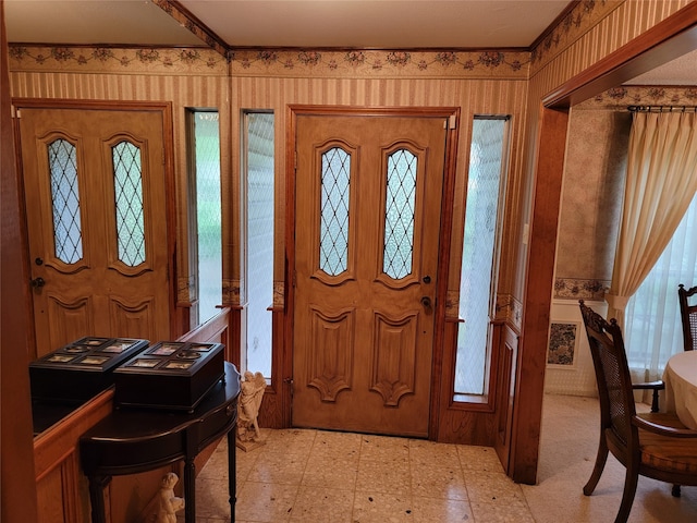 foyer featuring plenty of natural light and light tile floors