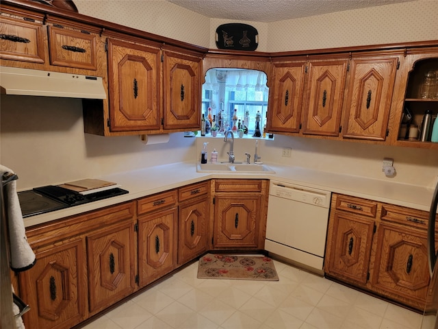 kitchen with sink, light tile flooring, white dishwasher, and black gas stovetop