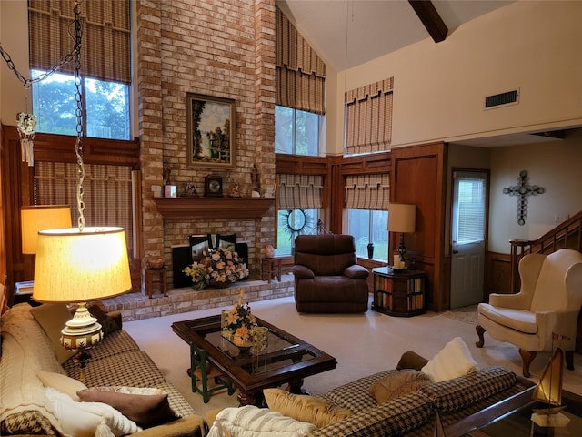 carpeted living room featuring high vaulted ceiling, beam ceiling, and a fireplace