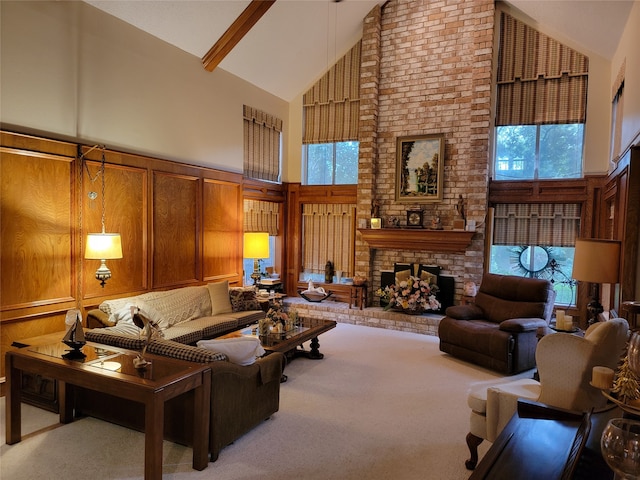 carpeted living room featuring high vaulted ceiling, a brick fireplace, brick wall, and plenty of natural light