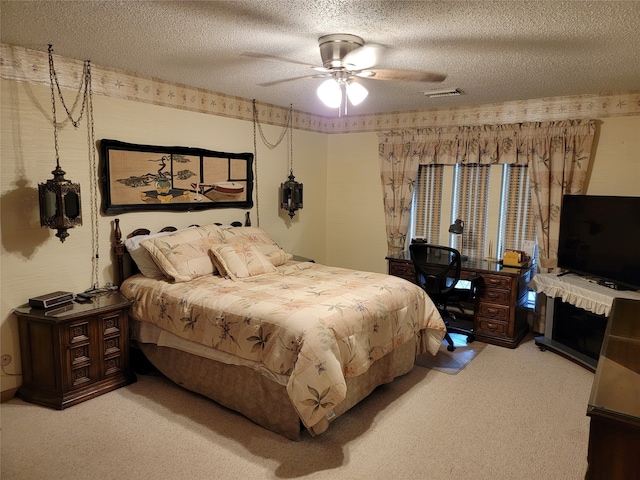 bedroom with ceiling fan, a textured ceiling, and carpet flooring