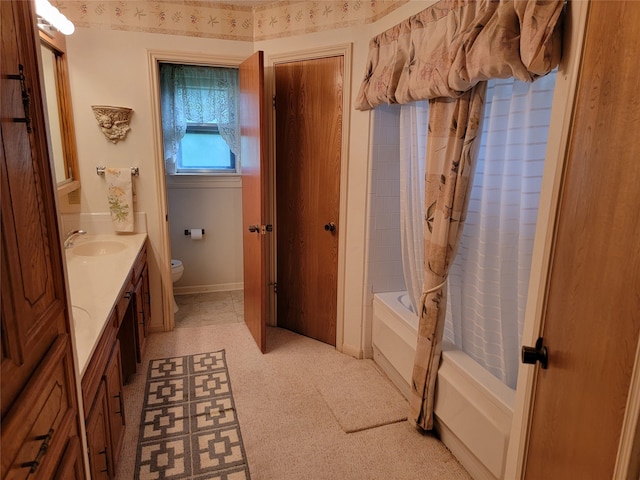 full bathroom featuring tile floors, toilet, shower / bath combo with shower curtain, and vanity