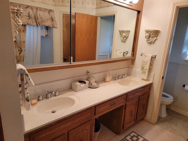 bathroom featuring tile floors, dual bowl vanity, and toilet