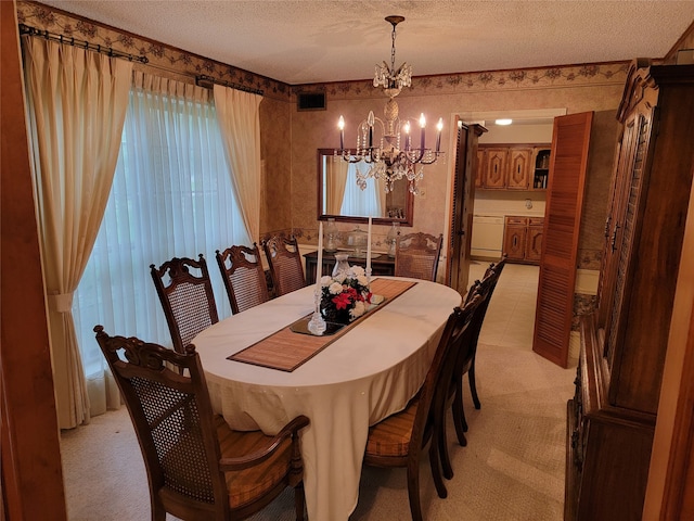 carpeted dining room with a textured ceiling and a chandelier