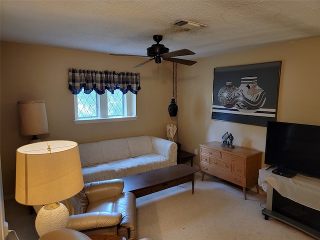 carpeted bedroom with a textured ceiling and ceiling fan