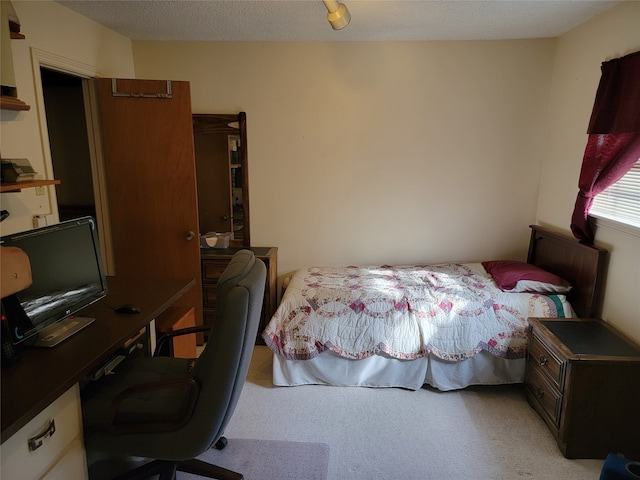 carpeted bedroom with a textured ceiling