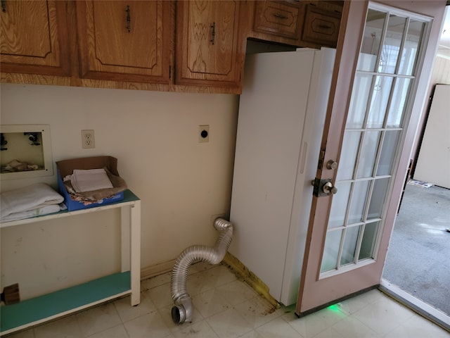 laundry area with hookup for a washing machine, cabinets, light tile floors, and hookup for an electric dryer