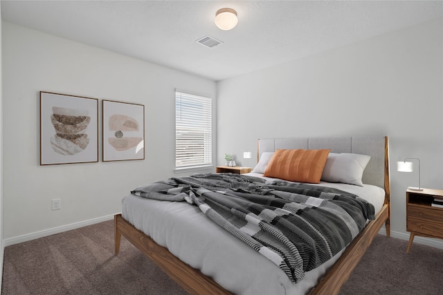 bedroom featuring dark colored carpet