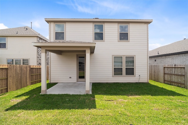 rear view of property with a patio and a lawn