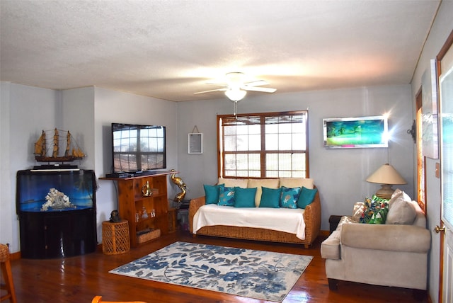 living room featuring a textured ceiling, ceiling fan, and hardwood / wood-style floors