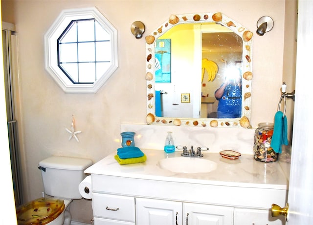 bathroom featuring oversized vanity and toilet