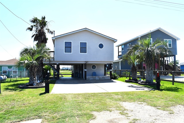 beach home with a front yard and a carport