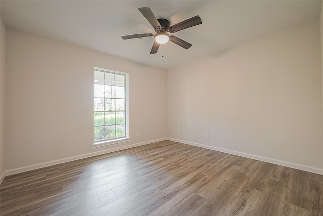 empty room with wood-type flooring and ceiling fan