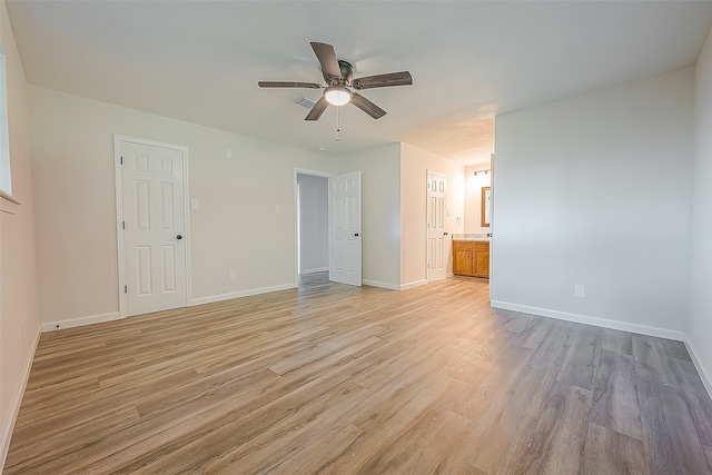 unfurnished bedroom featuring connected bathroom, ceiling fan, and light wood-type flooring