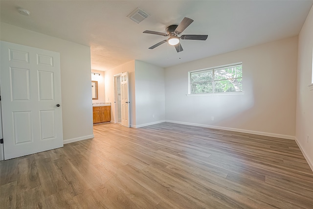 spare room featuring hardwood / wood-style floors and ceiling fan