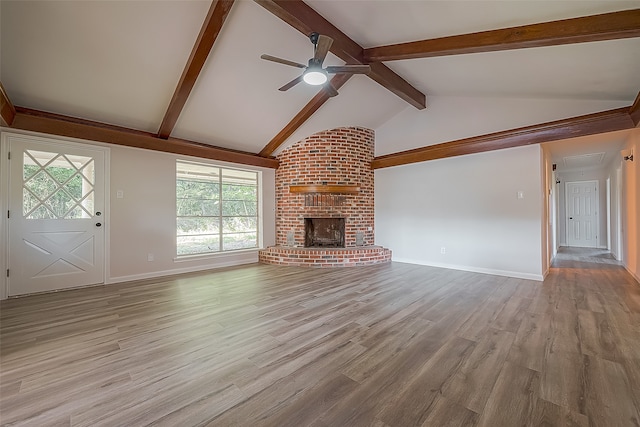 unfurnished living room featuring vaulted ceiling with beams, hardwood / wood-style floors, and a brick fireplace