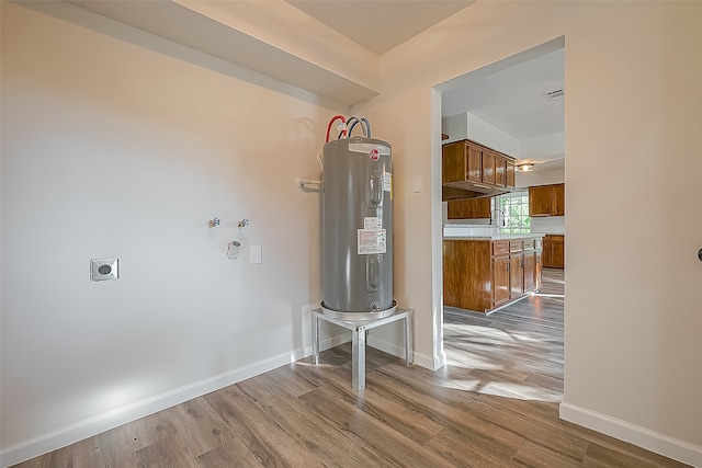 interior space featuring water heater and hardwood / wood-style flooring