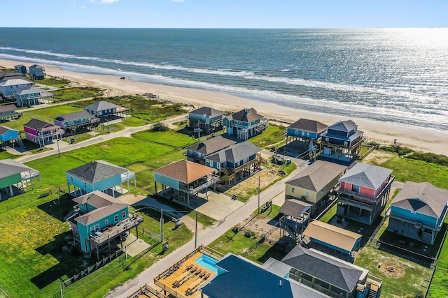 birds eye view of property featuring a beach view and a water view