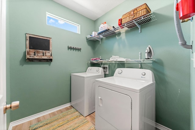 washroom with independent washer and dryer and light wood-type flooring