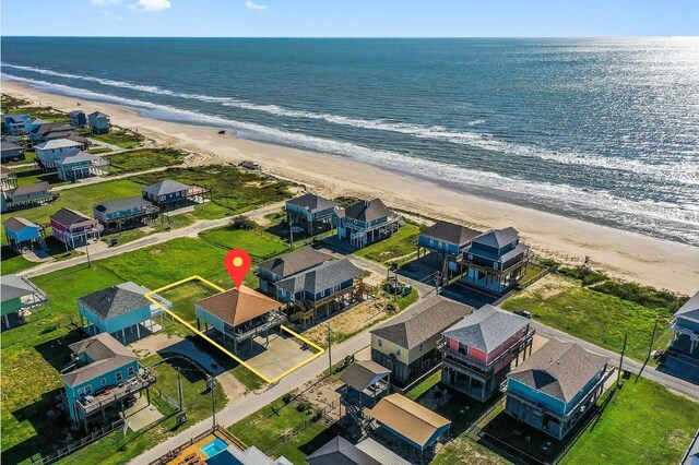 birds eye view of property with a water view and a view of the beach