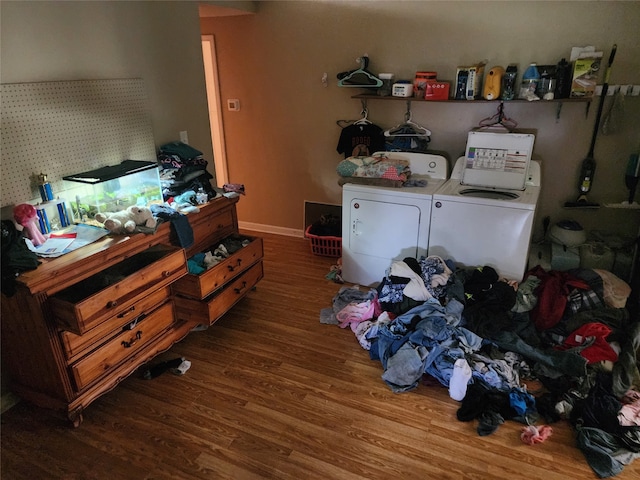 interior space with independent washer and dryer and hardwood / wood-style flooring