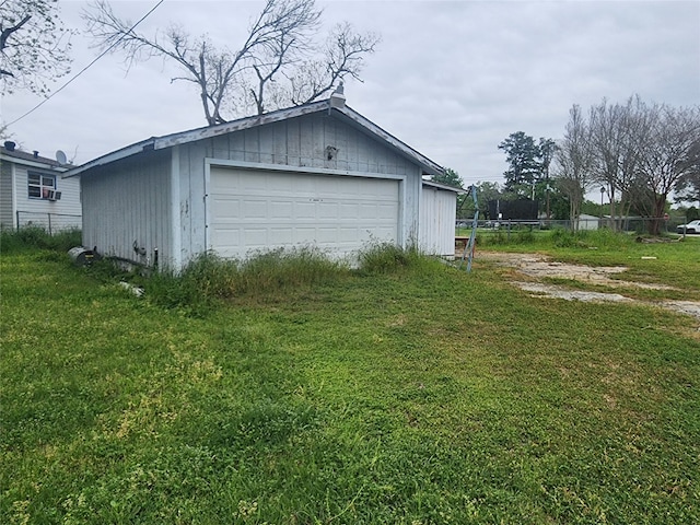 view of side of home with a garage, a yard, and an outdoor structure