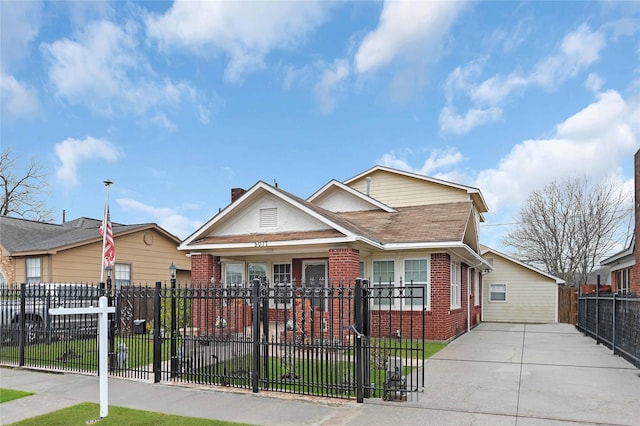 bungalow-style house with brick siding and a fenced front yard