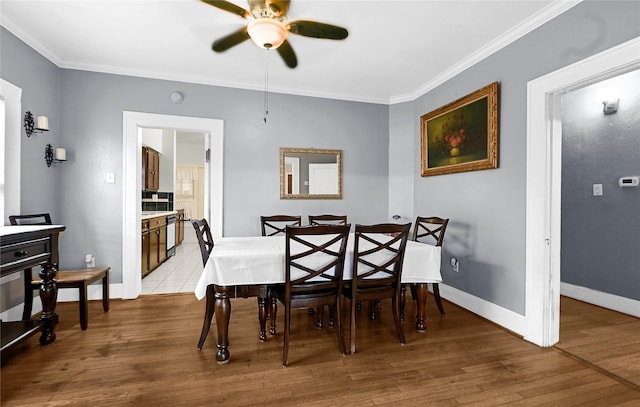 dining area with crown molding, light hardwood / wood-style flooring, and ceiling fan