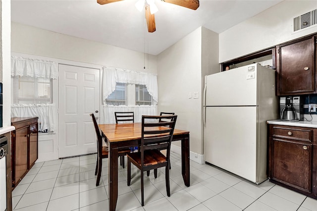 tiled dining room featuring a wealth of natural light and ceiling fan