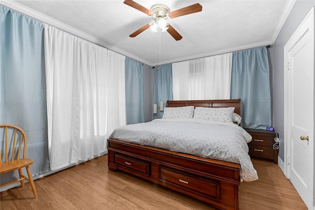 bedroom featuring ornamental molding, ceiling fan, and light hardwood / wood-style flooring